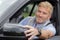 Mature man adjusting car wing mirror