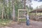 Mature man with backpack playing wooden xylophone on ecological trail