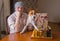 Mature man with basenji dog sitting at the table and waiting for rival in a chess family tournament