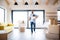 Mature man with boxes moving in new unfurnished house, walking.