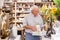 Mature man buying indian souvenir statue