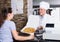 Mature man chef serving fresh pizza to customer