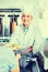 Mature man chef wearing uniform giving kebab plate to customer