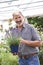 Mature Man Choosing Plants At Garden Center