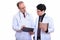 Mature man doctor holding clipboard with young man doctor holdin