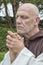 Mature man dressed as a traditional monk.