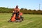 Mature man driving grass cutter