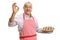 Mature man with a freshly baked pie making an ok sign