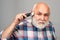 Mature man with hair clipper. Old bald man hair clipper, Mature baldness and hair loss concept.