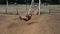 Mature man have fun and enjoy children fun park using long swing. Adult people in playful lifestyle no limit age. Enjoy vacation