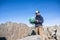 Mature man hiking in mountains in summer, using map.