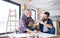 A mature man with his senior father assembling furniture, a new home concept.