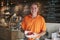 Mature Man Holding Healthy Breakfast In Coffee Shop