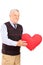 Mature man holding red heart