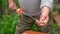 Mature man impales raw shashlik on skewer. Close up of men\'s hands hold skewer with barbecue. Concept of picnic outdoor.