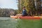 Mature man with kayak in a lake