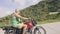 Mature man motorcyclist traveling on motorbike on tropical nature landscape. Senior man driving on motorcycle in