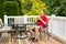 Mature man resting in chair on outdoor patio with cup of coffee