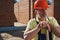 Mature man resting on construction site with spade