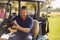 Mature Man Sitting In Buggy Playing Round On Golf And Checking Score Card