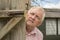 Mature man spying round a wooden door