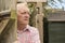 Mature man spying round a wooden door