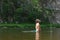 Mature man standing in water and throwing his long wet hair back. Tourism, active leisure, bath, soft and silky hair