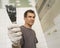 Mature Man Tiling the Bathroom with Trowel