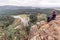 Mature man A tourist sits on a rock and looks afar to the Ural Mountains