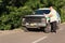 A mature man using his phone next to his pickup truck