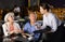 Mature man and woman reads menu and makes order to waitress