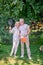 Mature mand and woman with rackets looking enjoyed and happy