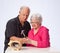 Mature Married Couple Breaking into Piggy Bank