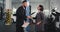 Mature mechanic guy and attractive lady sign some documents before going to the car to check the problem in a auto