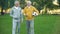 Mature men in sportswear walking in park with ball, sport hobby, health care