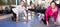 Mature men and women are engaged on mat in gym