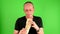 Mature mid aged man. Portrait of a mature man eats the fast food - kebab also called gyros in front of green screen.