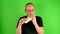 Mature mid aged man. Portrait of a mature man eats the fast food - kebab also called gyros in front of green screen.