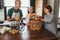 Mature middle-aged woman brings fresh vegetables from country to her friends to make healthy dinner