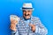 Mature middle east man with mustache wearing elegant vintage style holding euros banknotes smiling happy pointing with hand and