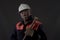 Mature miner covered in coal dust holding a pick axe