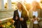 Mature multiracial businesswomen drinking coffee during walking