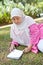 Mature Muslim woman enjoying the park with a book