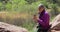 Mature nature loving woman using camera to take pictures of wildlife Zion Utah