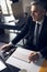 Mature office worker in suit working at computer indoors