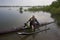Mature paddler in racing outrigger canoe
