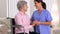 Mature patient happily talking with caregiver
