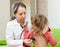 Mature pediatrician doctor examining child