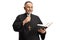 Mature priest reading a prayer from the bible and holding a microphone