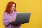 Mature redheaded woman having a problem with a laptop
